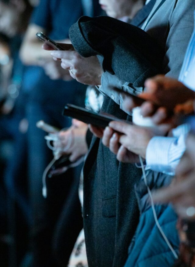 People on their phones - social media strategy that works