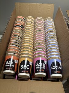MiSmile Media branded coffee sleeves.